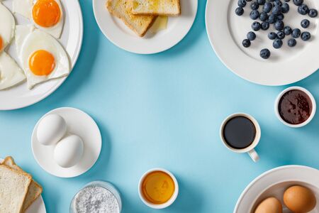 Top view of table setting for breakfast on blue backgroundの写真素材
