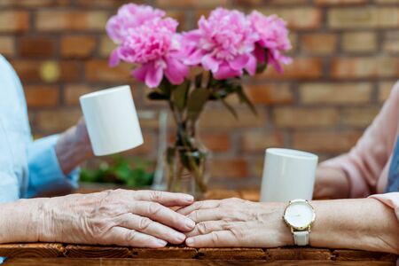 Cropped view of senior man touching hand of retired womanの写真素材