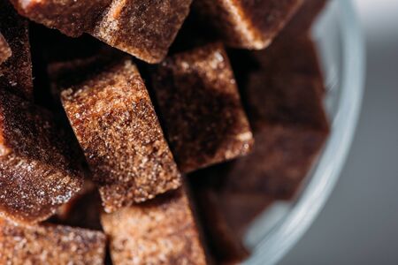 Close up view of sweet unrefined brown sugar cubesの写真素材
