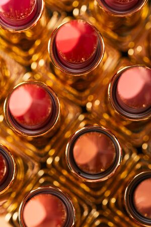 Top view of various red shades of lipstick in tubes