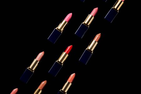Flat lay with various shades of lipsticks in tubes isolated on black backgroundの写真素材