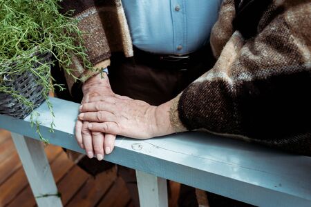 Cropped view of senior woman holding hands with man near green plantの写真素材