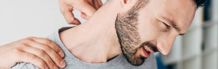 Panoramic shot of chiropractor massaging neck of manの写真素材