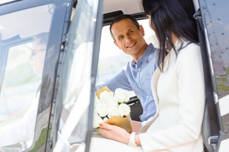 Husband and wife sitting in helicopter on romantic date