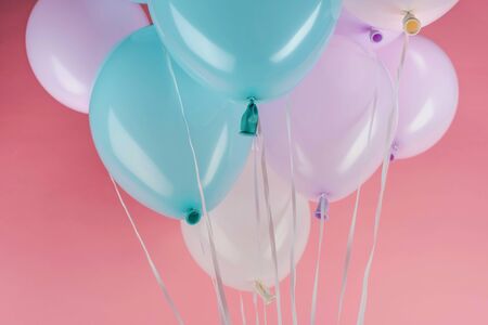Blue, white and purple festive balloons on pink backgroundの写真素材
