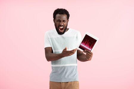 Emotional African American man showing digital tablet with graph app, isolated on blue background