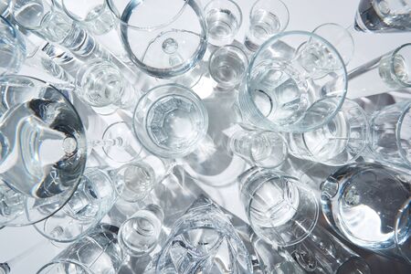 Top view of transparent glasses with water on white backgroundの写真素材