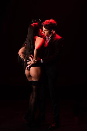 Full length view of hot bdsm couple on black backgroundの写真素材