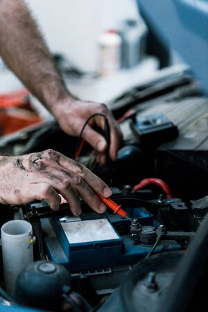 Cropped view of car mechanic working in car serviceの写真素材