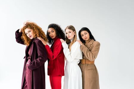 beautiful blonde and redhead women standing with african american girls on whiteの写真素材