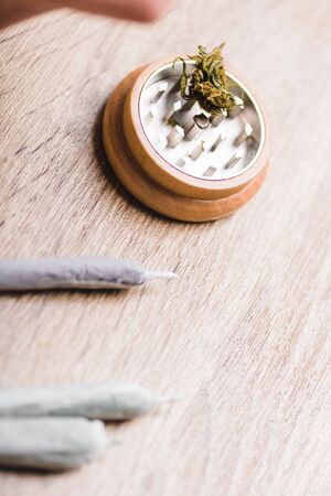 close up view of herb grinder and joints with medical marijuanaの写真素材
