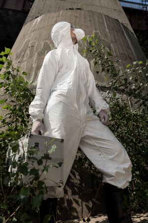 low angle view of ecologist with inspection kit standing near plantsの写真素材