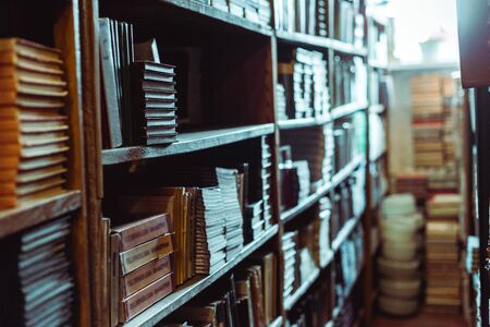 selective focus of retro books on wooden shelves in libraryの写真素材