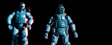 selective focus of toy plastic soldiers isolated on black, panoramic shot