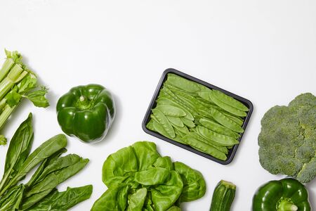 top view of green nutritious vegetables on white background with copy space