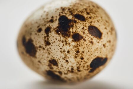selective focus of quail egg on white surfaceの写真素材