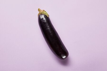 top view of ripe whole eggplant on violet background with copy spaceの写真素材