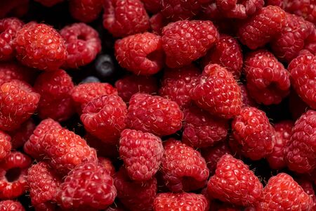 close up view of tasty ripe mixed raspberries and blueberriesの写真素材