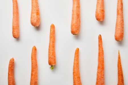 flat lay with fresh carrots on white backgroundの写真素材