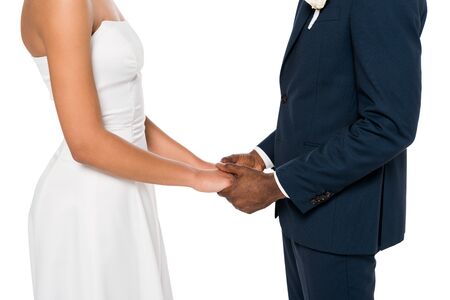 cropped view of african american bride and bridegroom holding hands isolated on whiteの写真素材