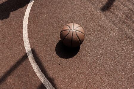 ball on brown playing surface at basketball courtの写真素材