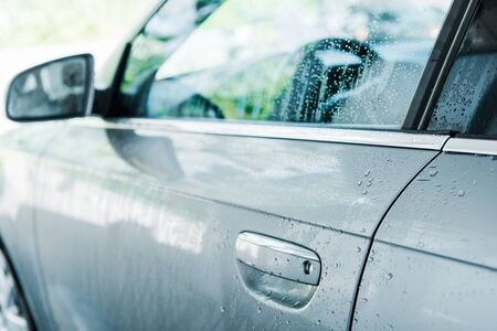 selective focus of drops of water on wet and clean car