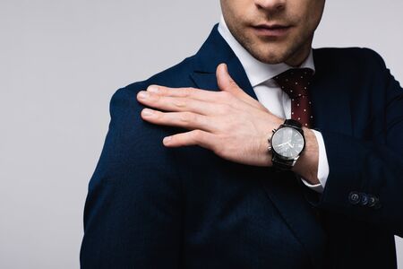 cropped view of businessman touching shoulder isolated on greyの写真素材