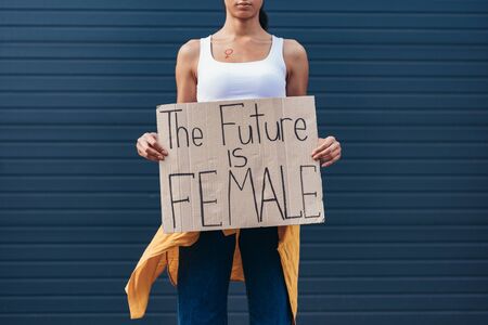 cropped view of feminist holding placard with inscription the future is femaleの写真素材