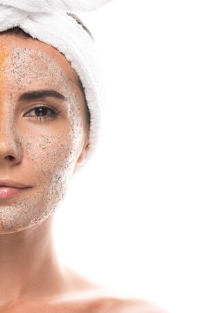 cropped view of young woman in cosmetic hair band with scrub on face isolated on whiteの写真素材