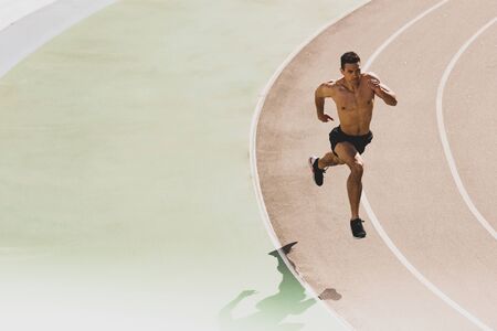 full length view of mixed race sportsman running at stadium