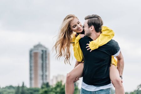 attractive woman and handsome man smiling and playing on roofの写真素材