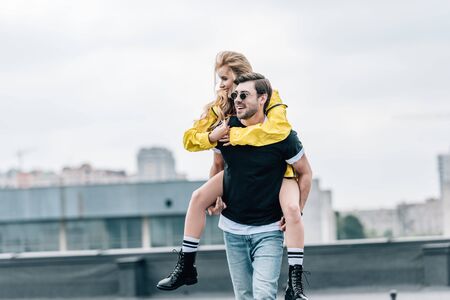 attractive woman and handsome man smiling and playing on roofの写真素材