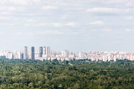 Urban scene with trees in city park, skyscrapers and buildingsの写真素材