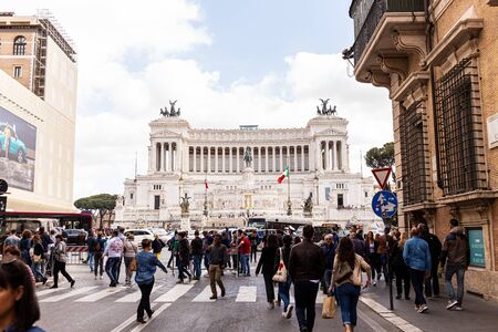 ROME, ITALY - JUNE 28, 2019: crowd of people walking on street near old buildingsのeditorial素材