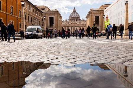 ROME, ITALY - JUNE 28, 2019: full length view of people walking on street near old buildingsのeditorial素材