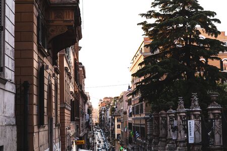 ROME, ITALY - JUNE 28, 2019: people and cars on street near old buildingsのeditorial素材