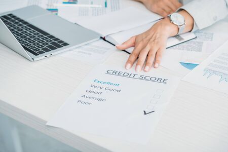 cropped view of woman showing credit score at officeの写真素材