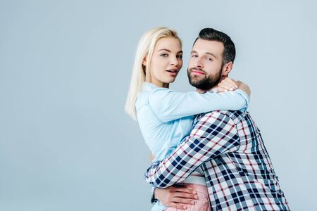 beautiful young couple embracing isolated on grey with copy spaceの写真素材