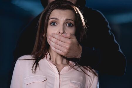 thief strangling frightened woman looking at cameraの写真素材