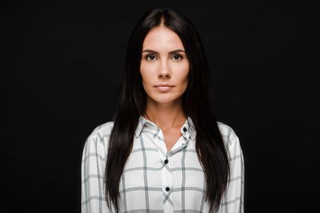 attractive young woman looking at camera isolated on black