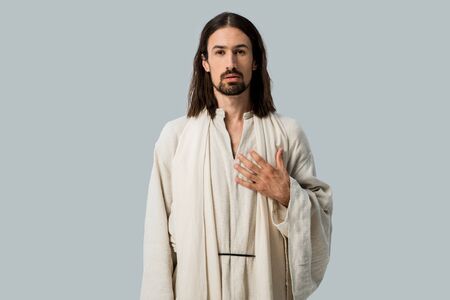 bearded man standing with hand on chest isolated on greyの写真素材