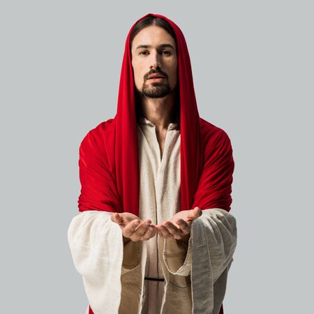 religious man standing with cupped hands and looking at camera isolated on grey