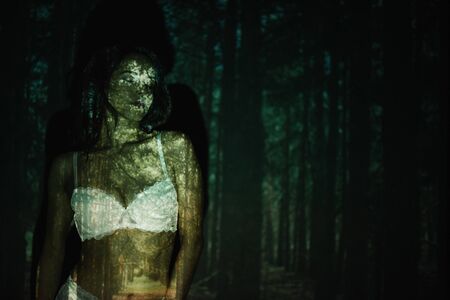 sexy girl standing in lace white bra near treesの写真素材