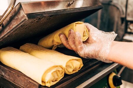 cropped view of cook in glove preparing doner kebabs in kebab grillの写真素材
