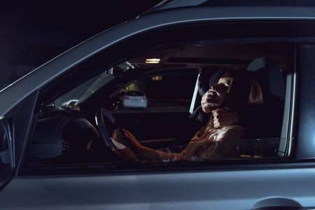 thief attacking beautiful frightened woman in automobile at night