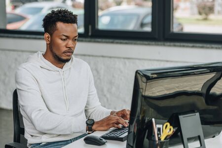 handsome african american programmer working on computer in officeの写真素材