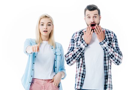 girl pointing with finger near surprised man covering mouth Isolated On White