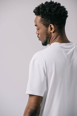 handsome african american man in white t-shirt isolated on greyの写真素材
