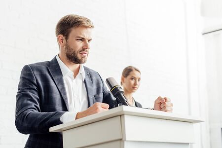 businessman in formal wear talking during conference in conference hallの写真素材