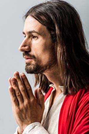 bearded and handsome man praying isolated on greyの写真素材